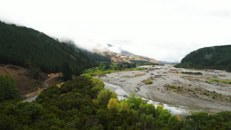 aerial-view-of-Wairau-River-in-Wairau-Valley-with-Southern-Alps-in-South-Island,-New-Zealand-foggy-landscape
