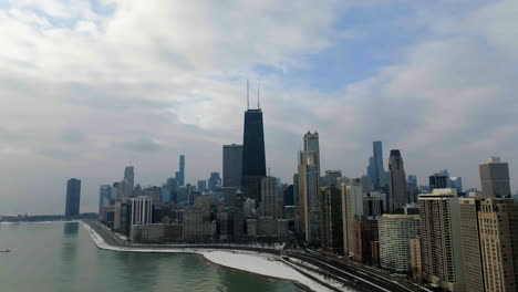 Drone-shot-around-the-lakeside-cityscape-of-the-Near-North-Side,-in-mostly-cloudy-Chicago,-USA