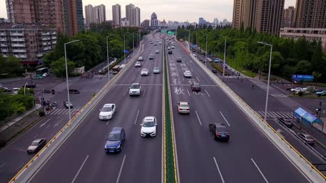 An-aerial-view-of-the-busy-Hangzhou-highway,-revealing-the-fast-paced-motion-of-cars,-trucks,-and-buses