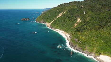 Sandy-beaches-and-forestry-cliff-of-west-coast-in-New-Zealand,-aerial-view