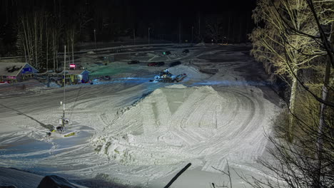 Making-ski-and-snowboard-jump-ramps-in-the-snow---nighttime-time-lapse