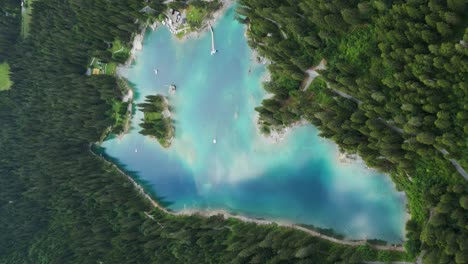 Aerial-View-Of-Reflective-Turquoise-Lake-Forest-At,-Caumasee-Switzerland