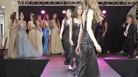 Front-on-shot-of-Miss-France-models-competing-wearing-black-sparkly-dresses