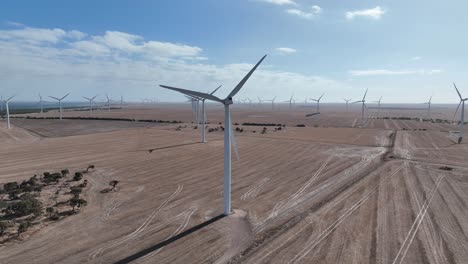 Tracking-drone-shot-of-spinning-wind-turbine