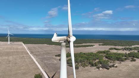 Stationary-slow-motion-drone-shot-of-spinning-wind-turbine