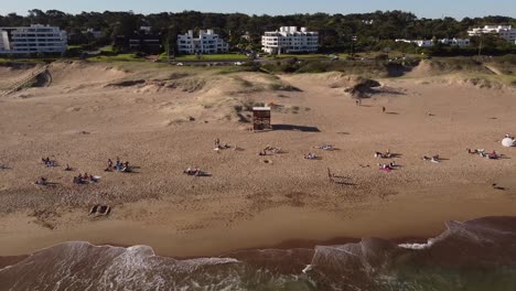 People-sunbathe-on-Playa-Brava-beach-on-sunny-day,-Punta-del-Este-in-Uruguay