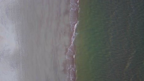 A-top-down-drone-shot-of-waves-hitting-the-shore-on-Hilton-head-island