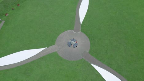 Capel-Le-Ferne-Battle-of-Britain-memorial-garden-propeller-design,-aerial-rising-view-looking-down