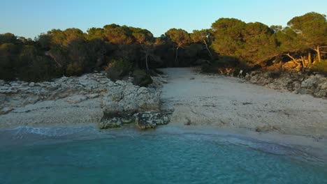 Tropical-island-oasis-in-Menorca-Spain-with-sunset-drone-flight