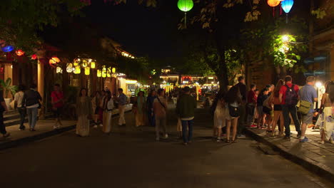 Hand-held-shot-of-tourists-exploring-the-street-and-shops-in-downtown-Hoi-An-at-night