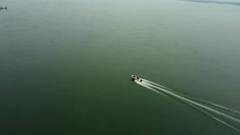 Tracking-Shot-Of-Boat-Sailing-Fast-Near-Shores-Of-Island-Of-Rio-Parana,-Paraguay