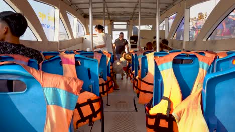 passengers-boarding-a-ferry-boat-and-taking-their-seats