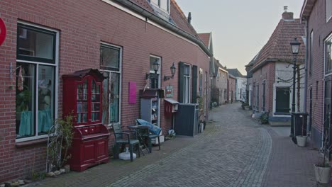 Wide-view-of-filled-bookcases-on-a-historical-old-road-in-the-small-castle-city-of-Bredevoort,-the-Netherlands