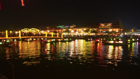 Timelapse-shot-of-the-busy-docks-with-tourists-waiting-to-go-on-the-bright-lantern-boats-in-Hoi-An