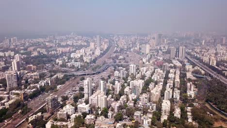 A-hazy-cityscape-of-Mumbai-from-above-with-bustling-metropolitan-city-with-its-skyscrapers,-traffic,-and-bustling-downtown