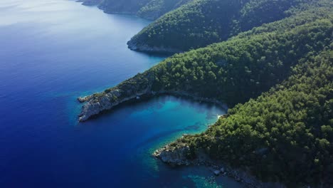 Aerial-view-from-drone-at-scenic-landscape-with-small-sunlit-bay-in-Aegean-Turkey