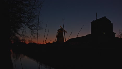Wide-pan-of-beautiful-Dutch-landscape-with-a-historical-windmill-in-the-background