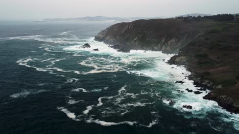 Panoramic-View-Of-Ocean-Waves-Hitting-Rocky-Cliffs-Near-Coastal-Park-In-Caion-Beach,-Coruna-Spain