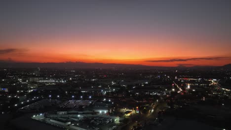 Aerial-view-over-the-cityscape-of-Mexico-city,-during-dusk---circling,-drone-shot