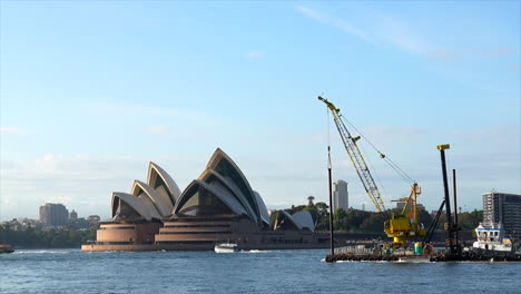 A-construction-crane-ship-passes-by-Sydney-opera-house-in-Australia