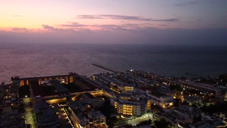 Aerial-Shot-Over-Playa-Del-Carmen-Stunning-Waterfront-After-Sunset,-Mexico