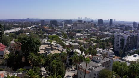 Aerial-reverse-pullback-shot-of-Hollywood-with-Downtown-Los-Angeles-in-the-distance