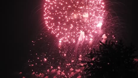 Red-fireworks-background-during-the-night,-still-shot-of-firework-in-slow-motion,-isolated-spectacular-fireworks