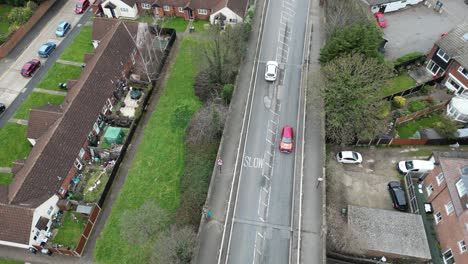 Cars-dangerous-swerving-around-large-potholes-UK-road-overhead-birds-eye-drone-aerial