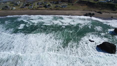 Beautiful-4K-birds-eye-aerial-drone-shot-over-Bandon-beach-with-waves-coming-towards-shoreline