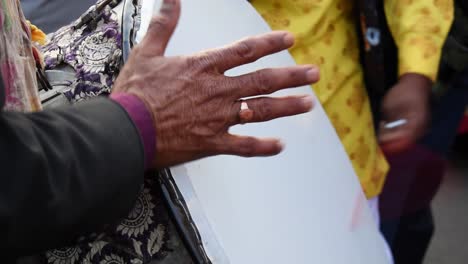 Playing-indian-drum-with-a-drumstick,-close-up-shot-of-couple-hands-playing-drum-or-dhol-intrument-with-a-stick