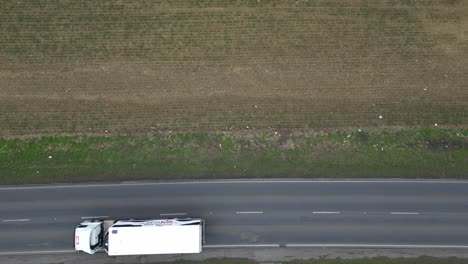 Trunks-and-cars-swerving-around-large-potholes-on-UK-roads-overhead-birds-eye-view-drone-aerial