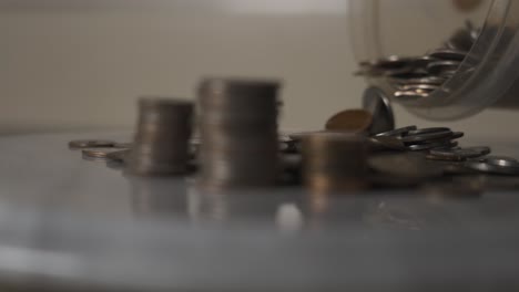 Adding-various-coins-to-a-pile-in-slow-motion