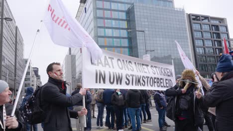 Farmers-protesting-against-the-Flemish-government's-measures-to-cut-down-nitrogen-emissions-with-banner-"Don't-let-us-choke-in-the-nitrogen-policy"---Brussels,-Belgium
