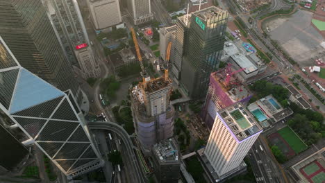 Drone-panning-shot-of-The-Henderson-office-tower-under-construction-in-Central,-Hong-Kong