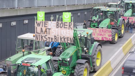 Farmers-protesting-against-the-Flemish-government's-measures-to-cut-down-nitrogen-emissions-with-sign-"If-you-choke-the-farmer,-you-have-nothing-to-eat"---Brussels,-Belgium