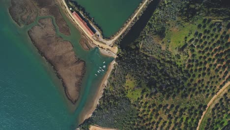 Ascending-aerial-view-over-fish-farm-outlet