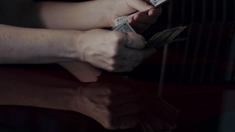 close-up-of-a-woman-hands-counting-money
