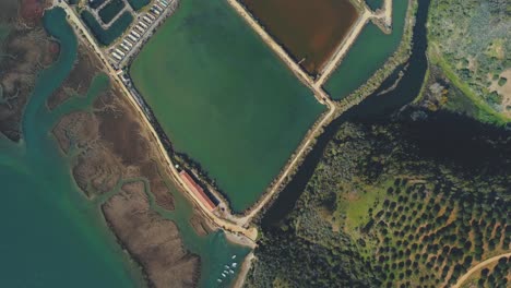 Topdown-perspective-looking-at-disused-discolored-fish-farm-pools