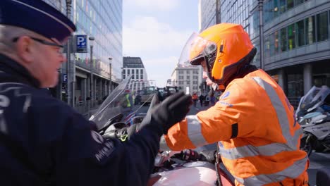 Belgian-police-officer-jumping-on-motorcycle-to-chase-criminal-activity-during-riot---Cinematic-shot---Brussels,-Belgium
