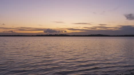 Timelapse-of-local-lake-in-county-Westmeath-in-Ireland-during-sunset-with-clouds-above-the-horizon