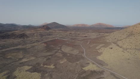 Cinematic-aerial-flight-over-Barron-volcanic-mountains-in-Lanzarote,-Spain