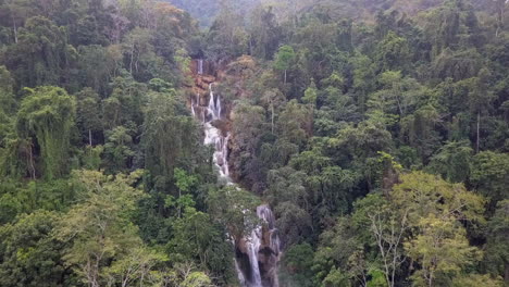 Laos-jungle-aerial-flight-to-dramatic-famous-tiered-Kuang-Si-waterfall