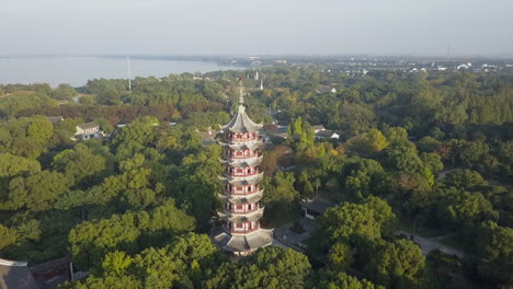 Tall-pagoda-in-Grand-View-Garden-area-of-Shanghai-China,-aerial-orbit
