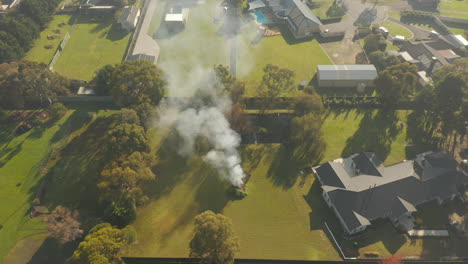 Smoke-billowing-out-from-controlled-burning-taking-place-in-small-farmland