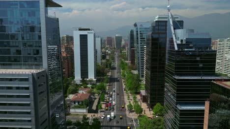 Slow-aerial-dolly-in-between-large-glass-skyscraper-offices-in-downtown-Lad-Condes