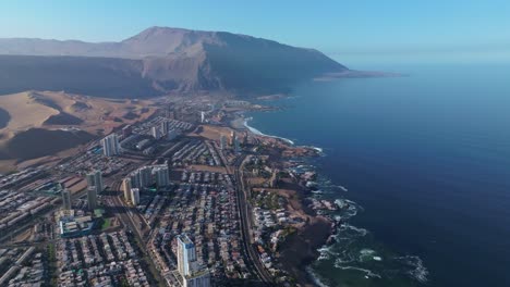 Slow-motion-aerial-shot-overhead-Iquique,-Chile-with-large-skyscrapers