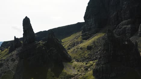Drone-view-passing-between-large-rocks-at-Old-Man-of-Storr-in-Scotland's-Isle-of-Skye