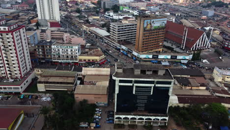 Aerial-view-of-buildings-on-the-Ave-Ahidjo-street,-in-Yaounde,-Cameroon---tracking,-drone-shot