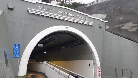 Mount-Victoria-Tunnel-built-in-1931-entrance-and-exit-with-traffic-in-capital-city-of-Wellington,-New-Zealand-Aotearoa