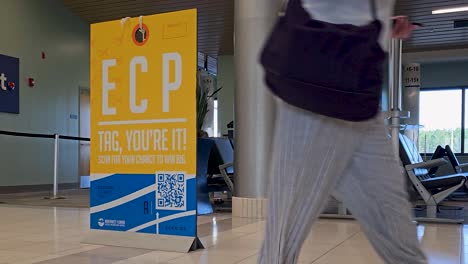 Passengers-walk-past-ECP-sign-traveling-through-Northwest-Florida-Beaches-International-Airport